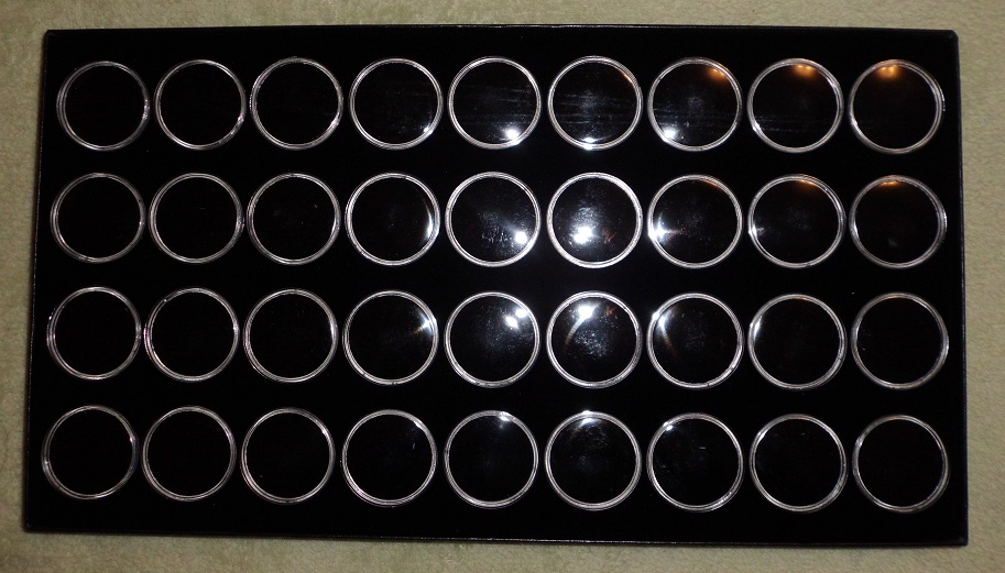Display case with 36 cups: relics, coins, gold nuggets